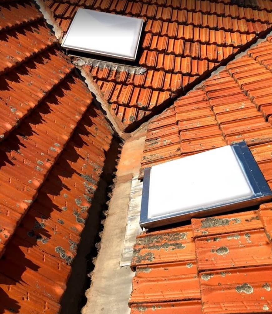 Two skylights on terracotta tile roof