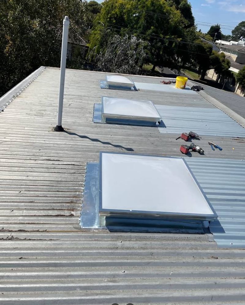 Three skylight installations on corrugated metal roof