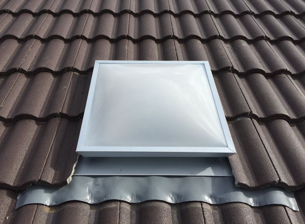 Tradesperson diagnosing skylight leak on metal roof Melbourne